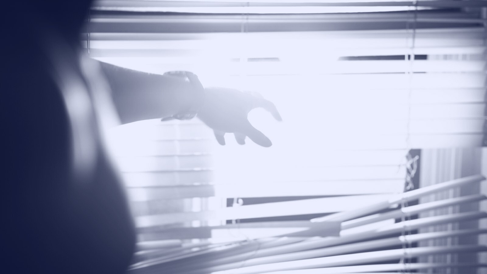 A person reaching out of a window with their hand