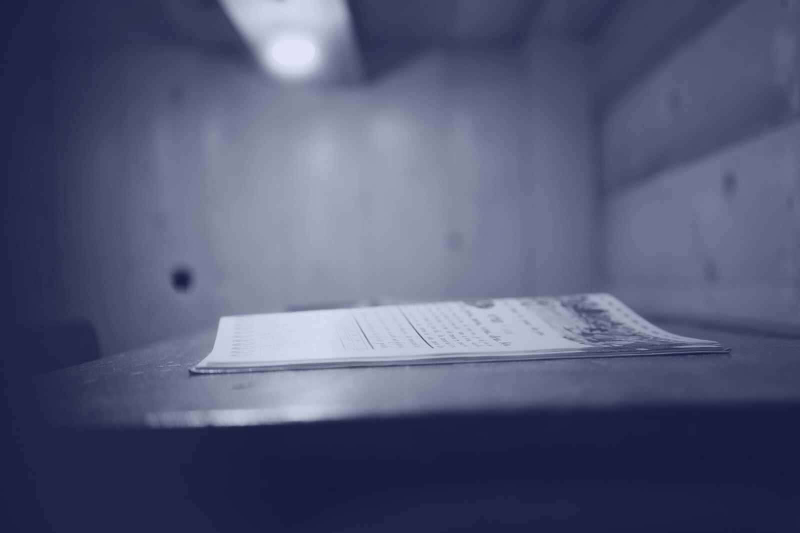 A document lies on a wooden table