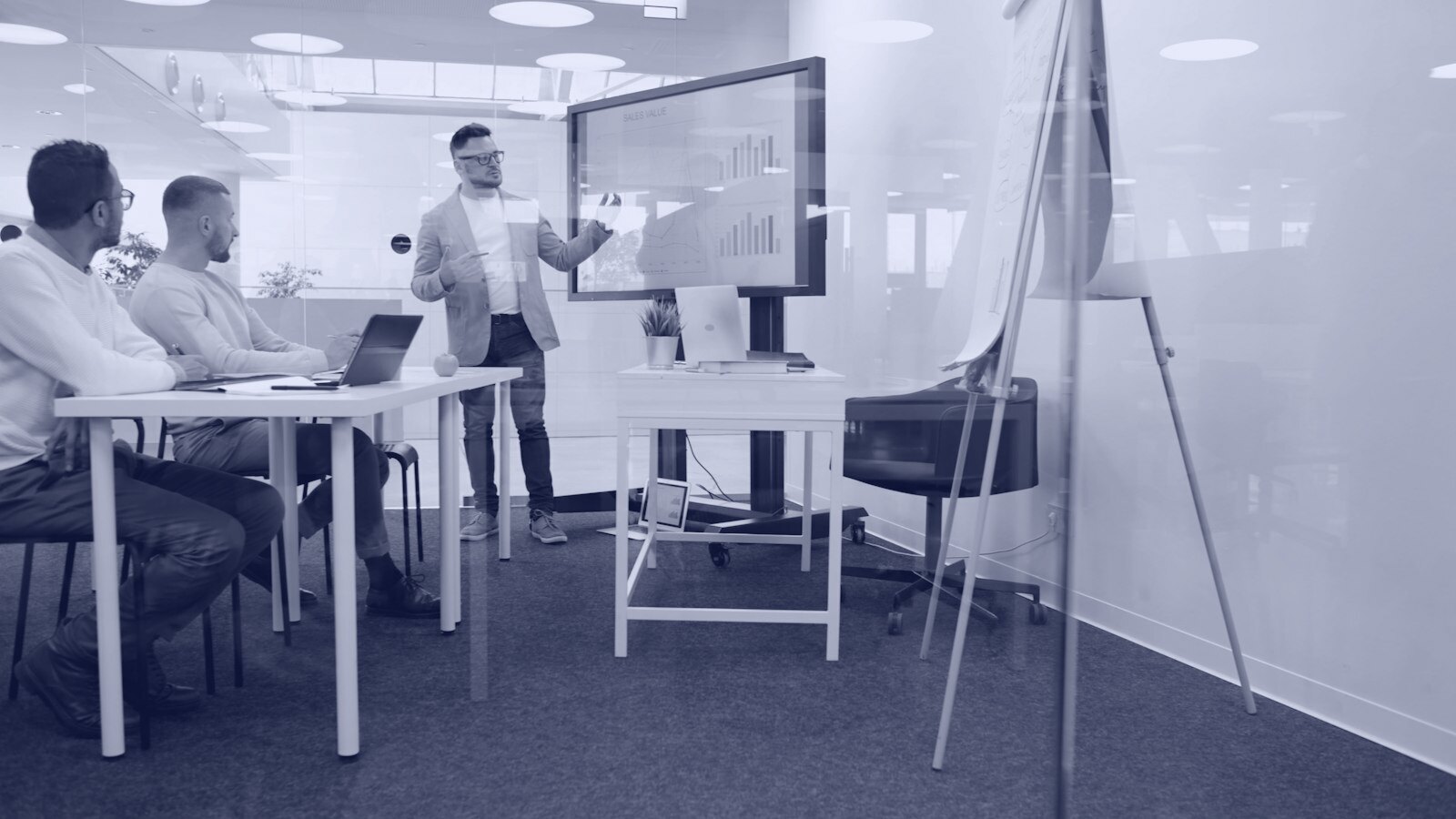 Man presenting to colleagues in a modern office