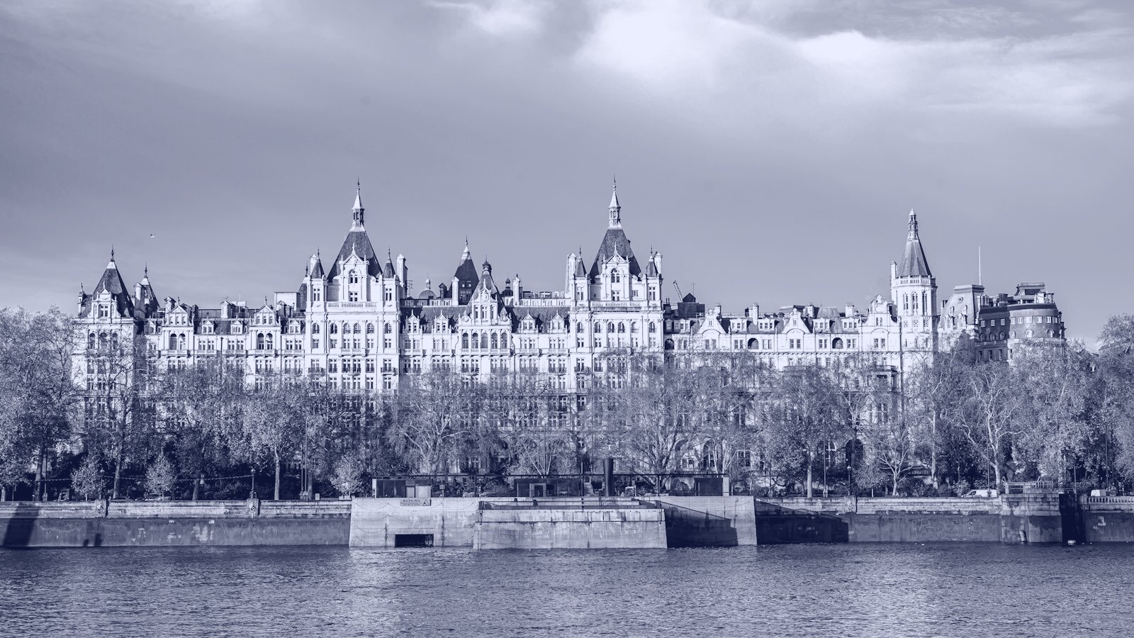 Grand building on the thames river under blue sky