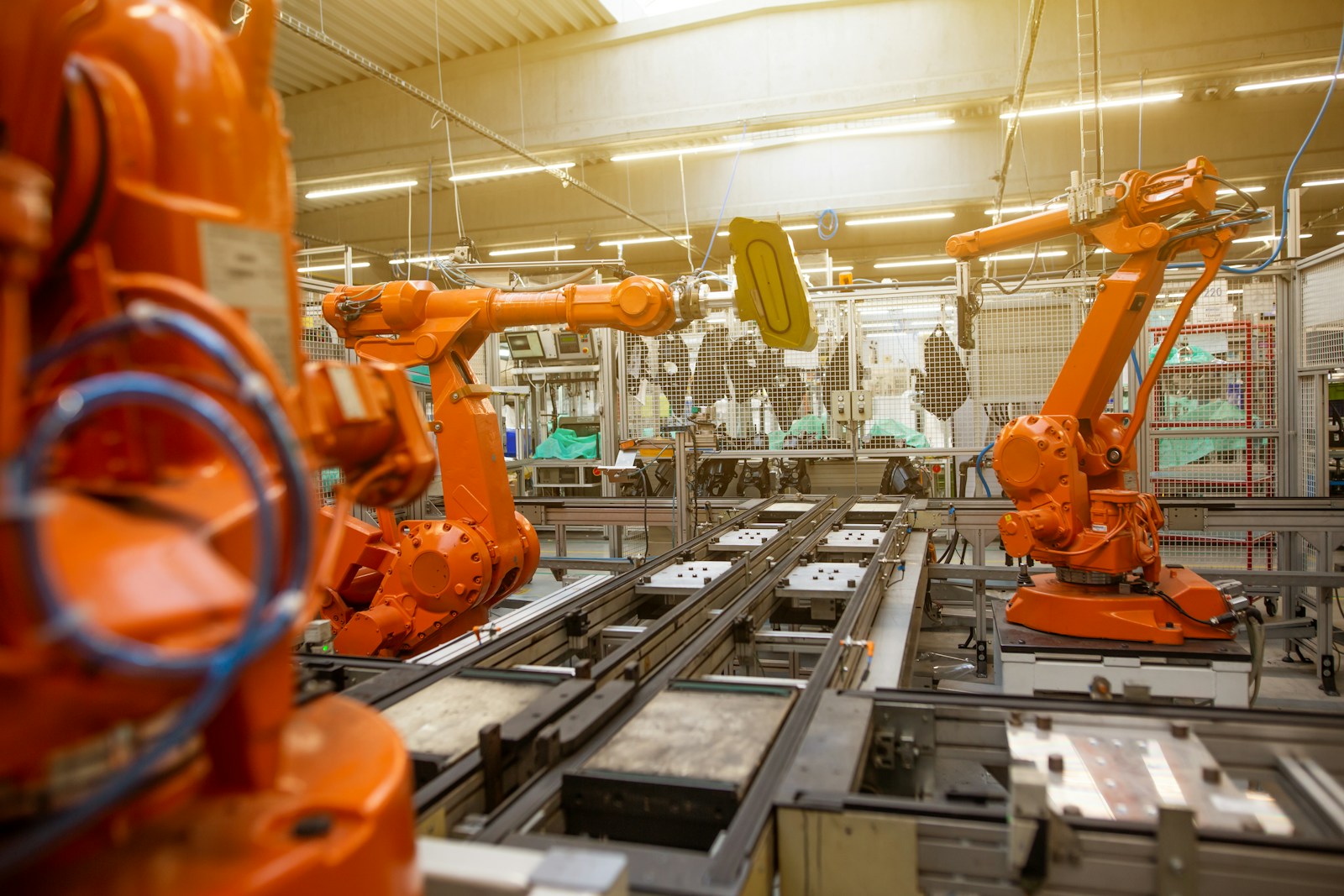 Robotic arms working along an automated factory assembly line